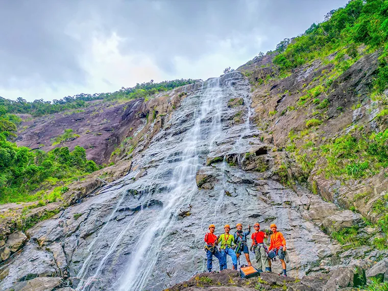 Crossing Do Quyen Waterfall at Adventure Peak, one of the unusual things to do in Da Nang