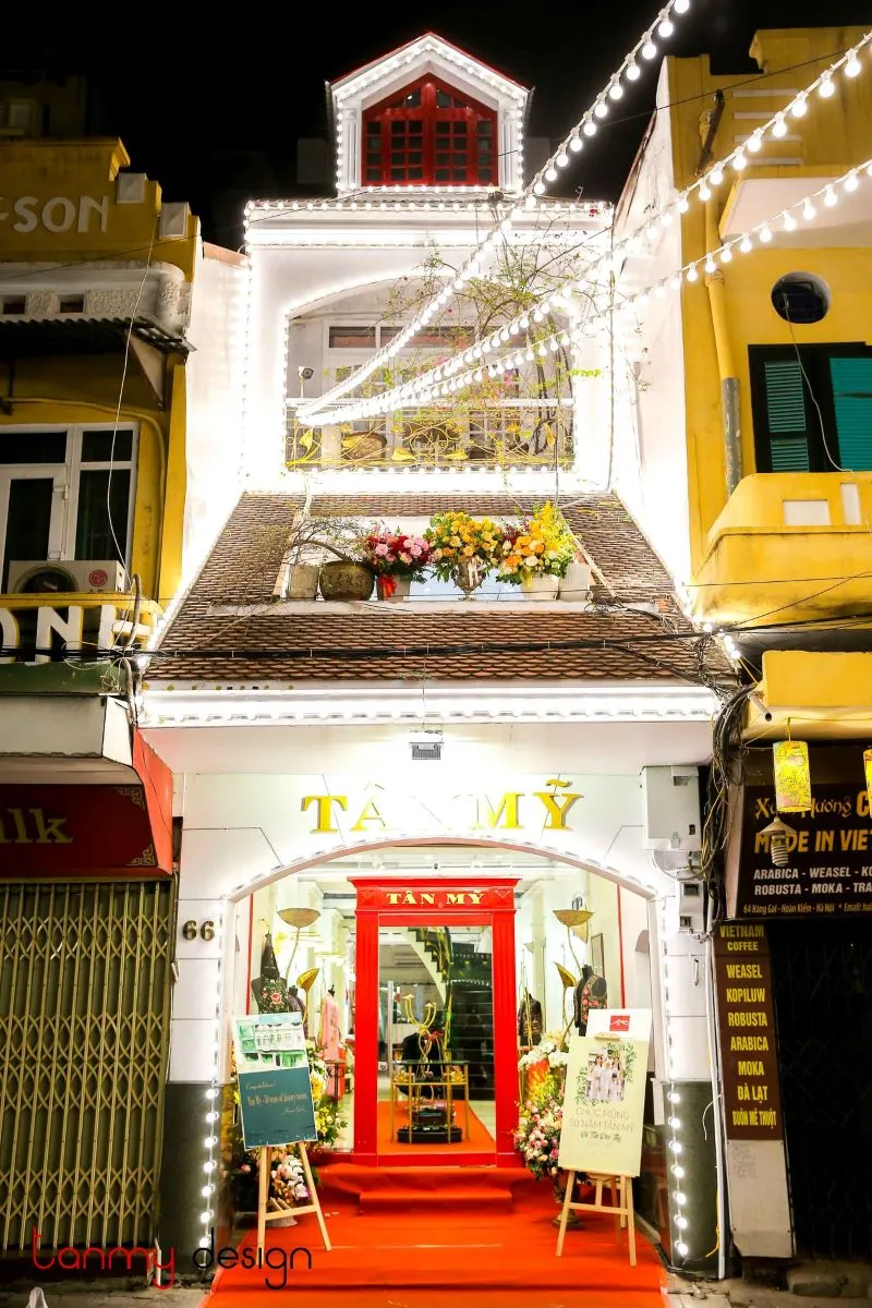 A luxurious silk scarf with intricate embroidery or the elegant interior of the store - Photo Source: Fanpage Tanmy Design