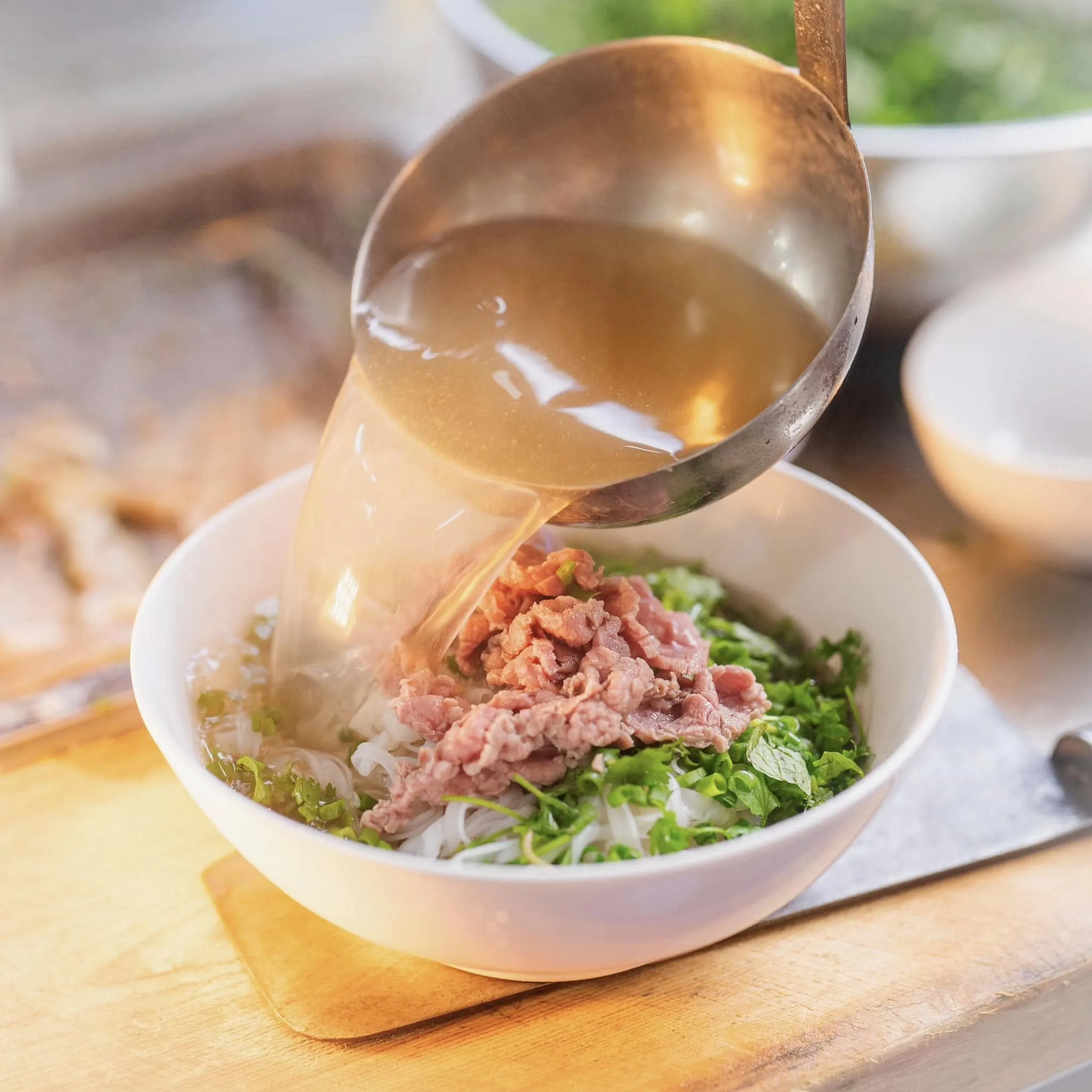 A simple, unpretentious sidewalk pho stall without a fancy signboard, creating a familiar atmosphere - Image source: Phở Gánh Hàng Chiếu