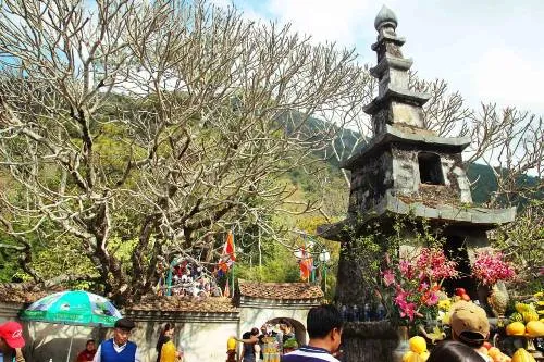 The pagoda showcases Nguyen Dynasty architecture with a grand entrance gate, bell tower, and altars blending Buddhist and folk religious elements