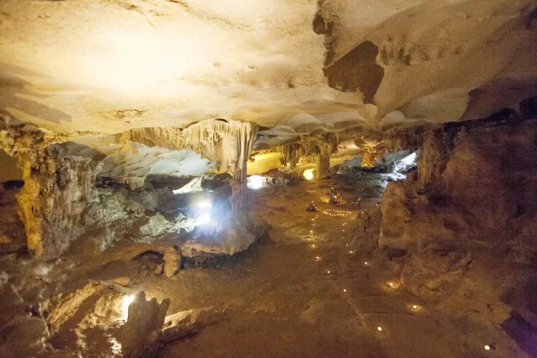 Inside the cave, stunning stalactites, natural light, and panoramic bay views create a magical underground landscape - Photo Source: baoquangninh