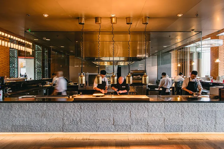 Diners observe the impressive food preparation process at French Grill restaurant