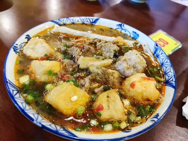 Vibrant and tangy crab noodle soup with fresh toppings