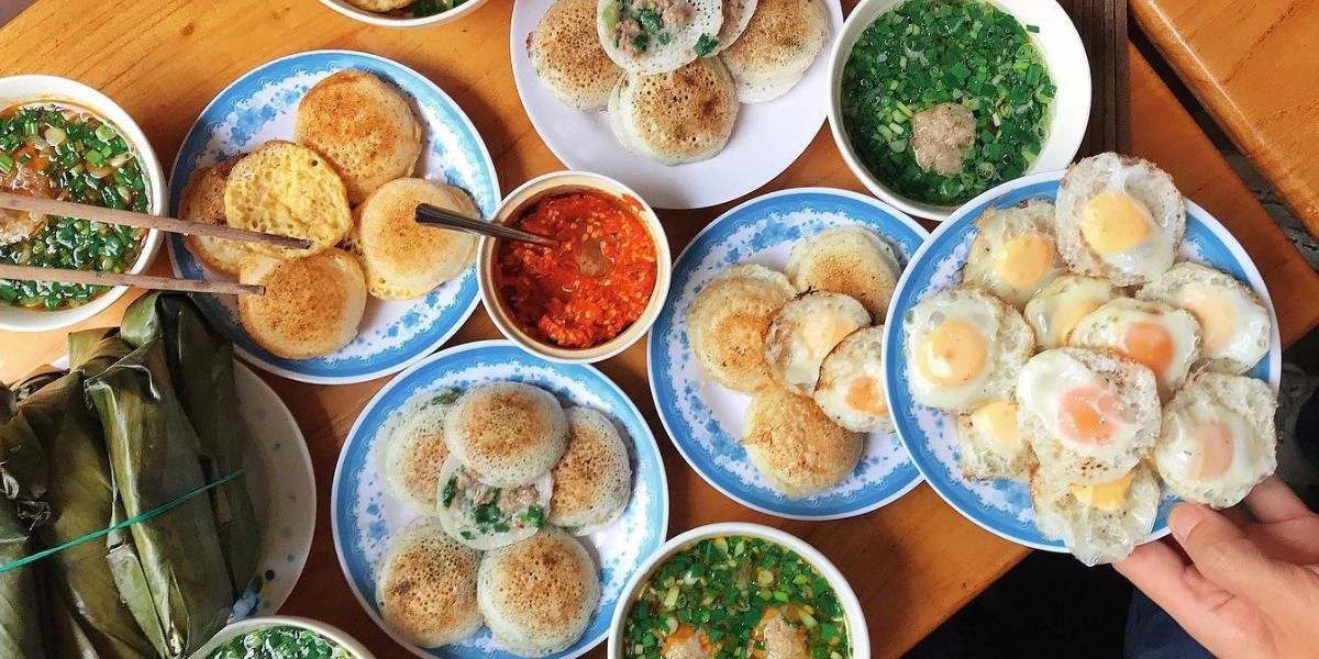Enjoy hot banh can with dipping sauce