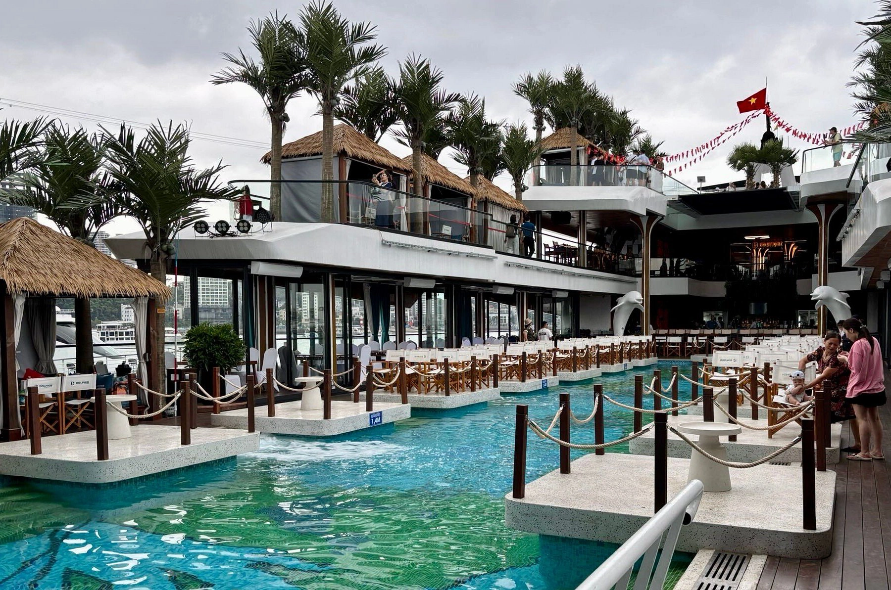 Dolphin Luxury Day Cruise | Explore Ha Long Bay with Sung Sot Cave, Ti Top Island & Sunset DJ Pool Party | 6-Star Beach Club Experience