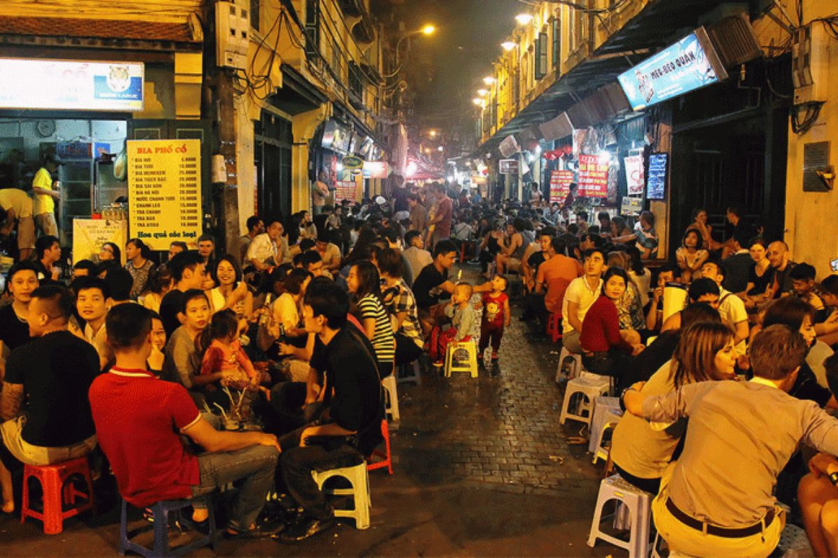 Crowds gather on small plastic stools for fresh beer on Ta Hien Street