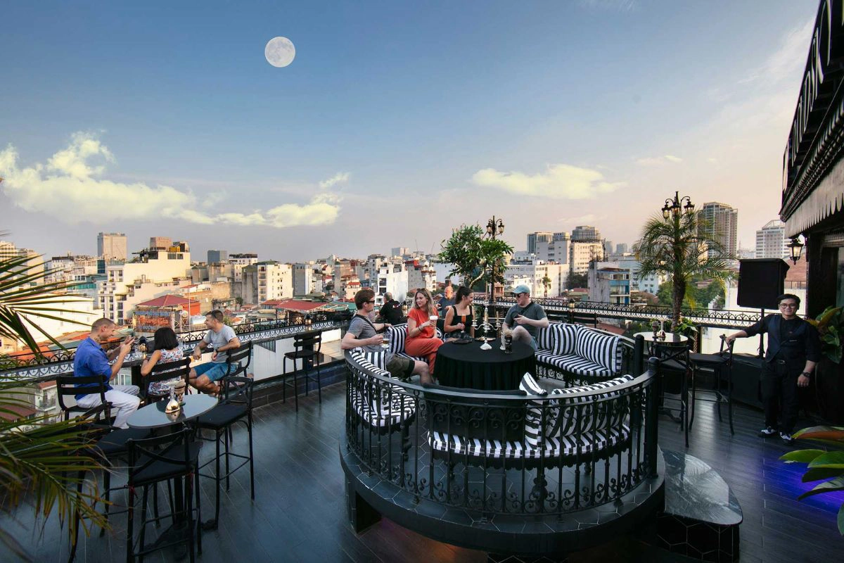 Sunset skyline framed by Solar Sky Bar’s red lanterns