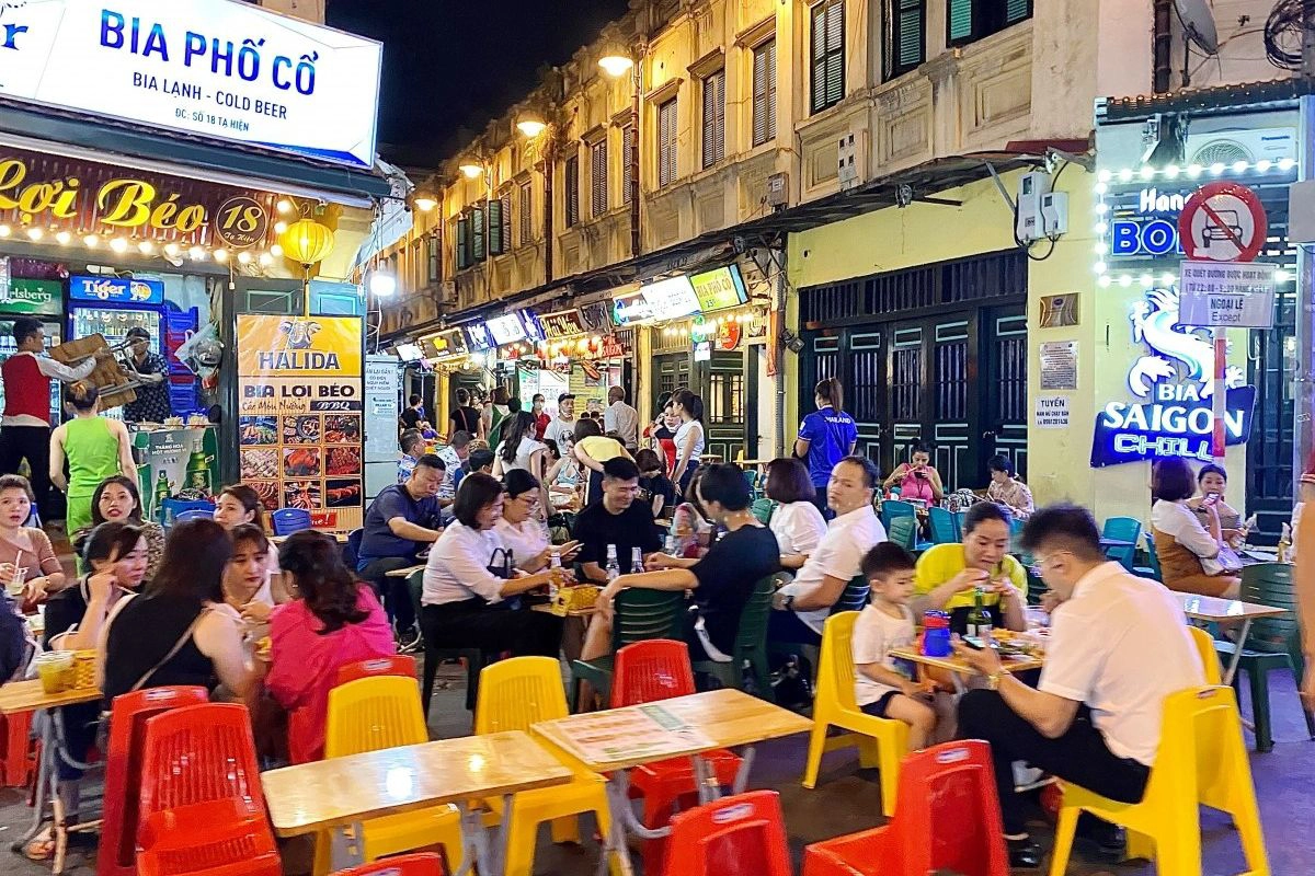 Locals enjoying fresh beer on plastic stools