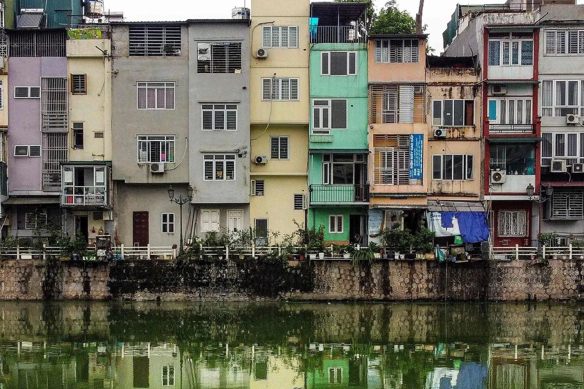 Tall and narrow tube houses lining a city street 