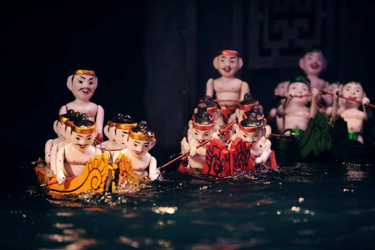 Wooden puppets performing on a water stage 