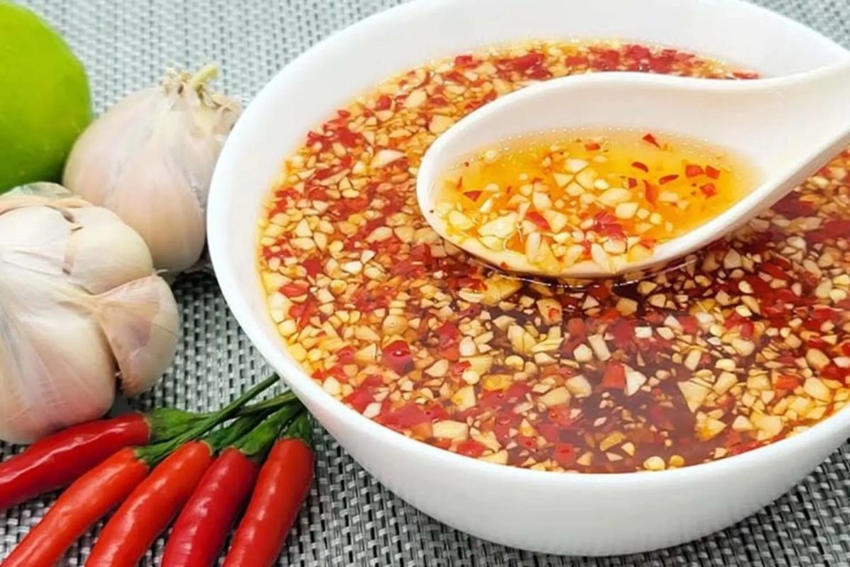 Customizing nuoc cham with lime chili and garlic vinegar