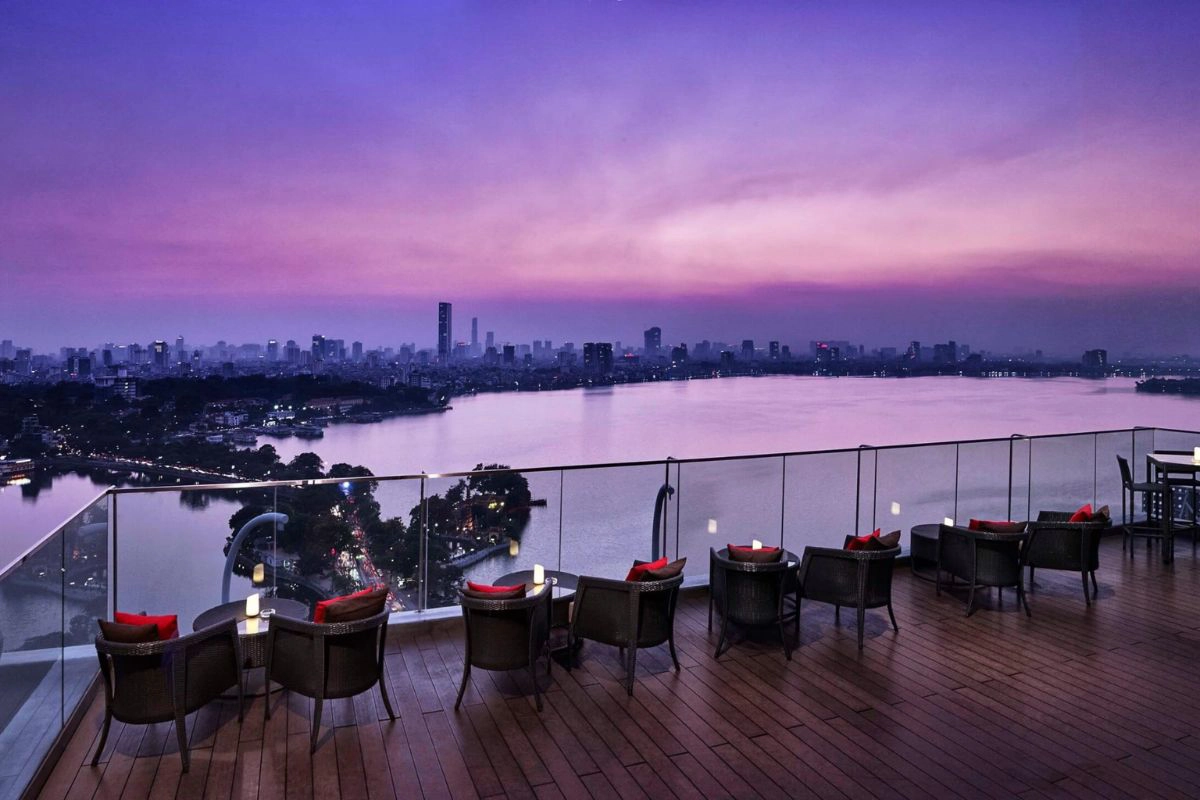 A tranquil sunset view over the water taken from a comfortable outdoor café terrace