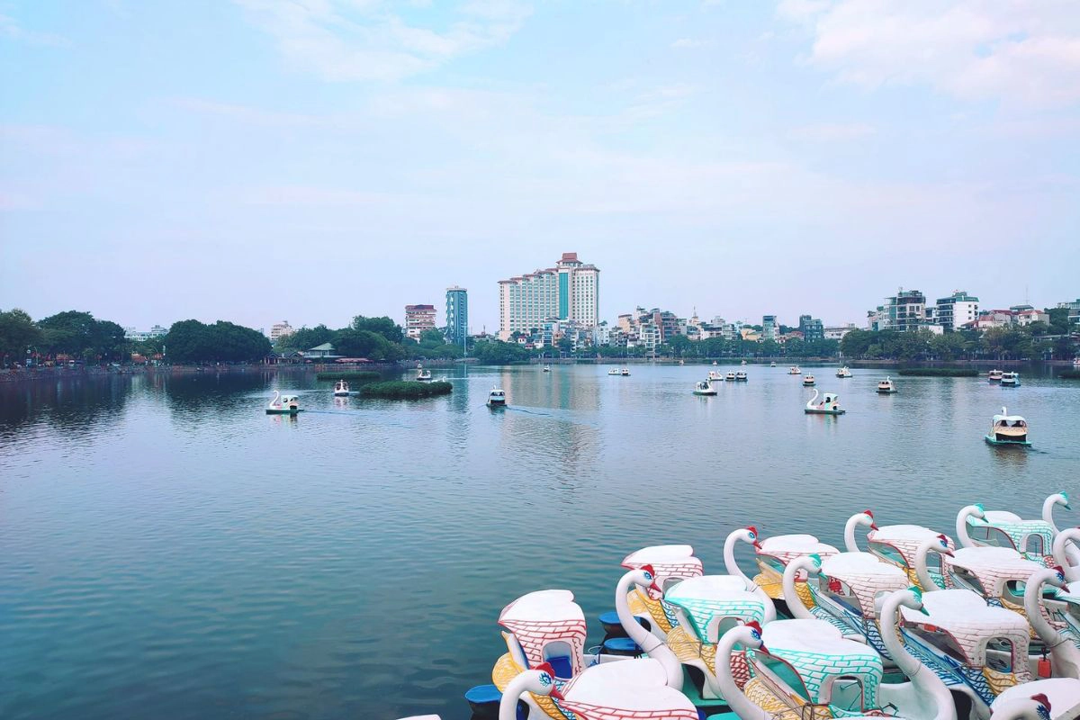 Colorful swan boats floating gently on the calm water near Thanh Nien Road
