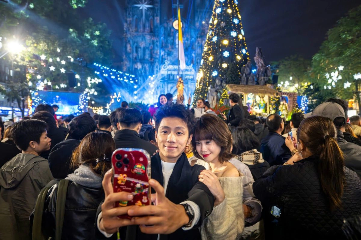 Crowds gather in warm winter clothing outside St. Joseph's Cathedral for Christmas