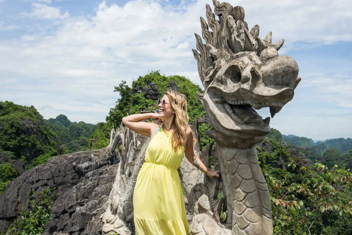 The iconic stone dragon statue overlooks the Ngo Dong River