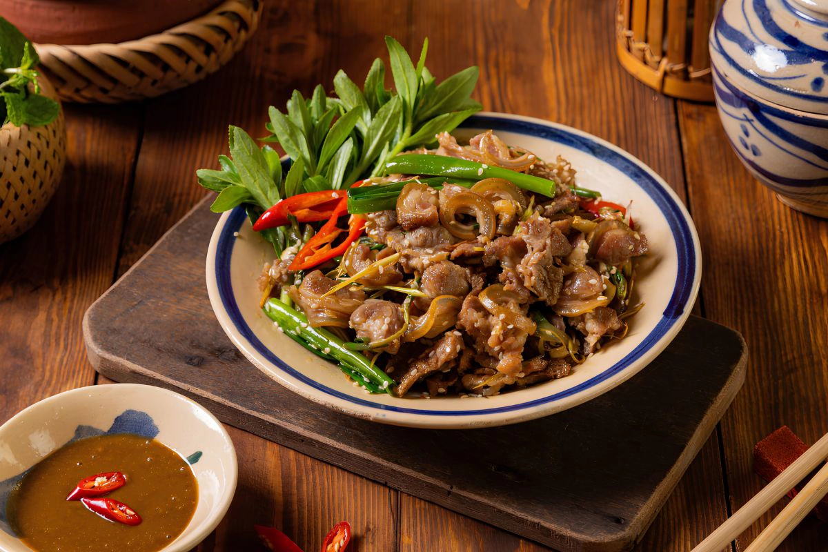 A hot pan of sizzling stir-fried goat meat