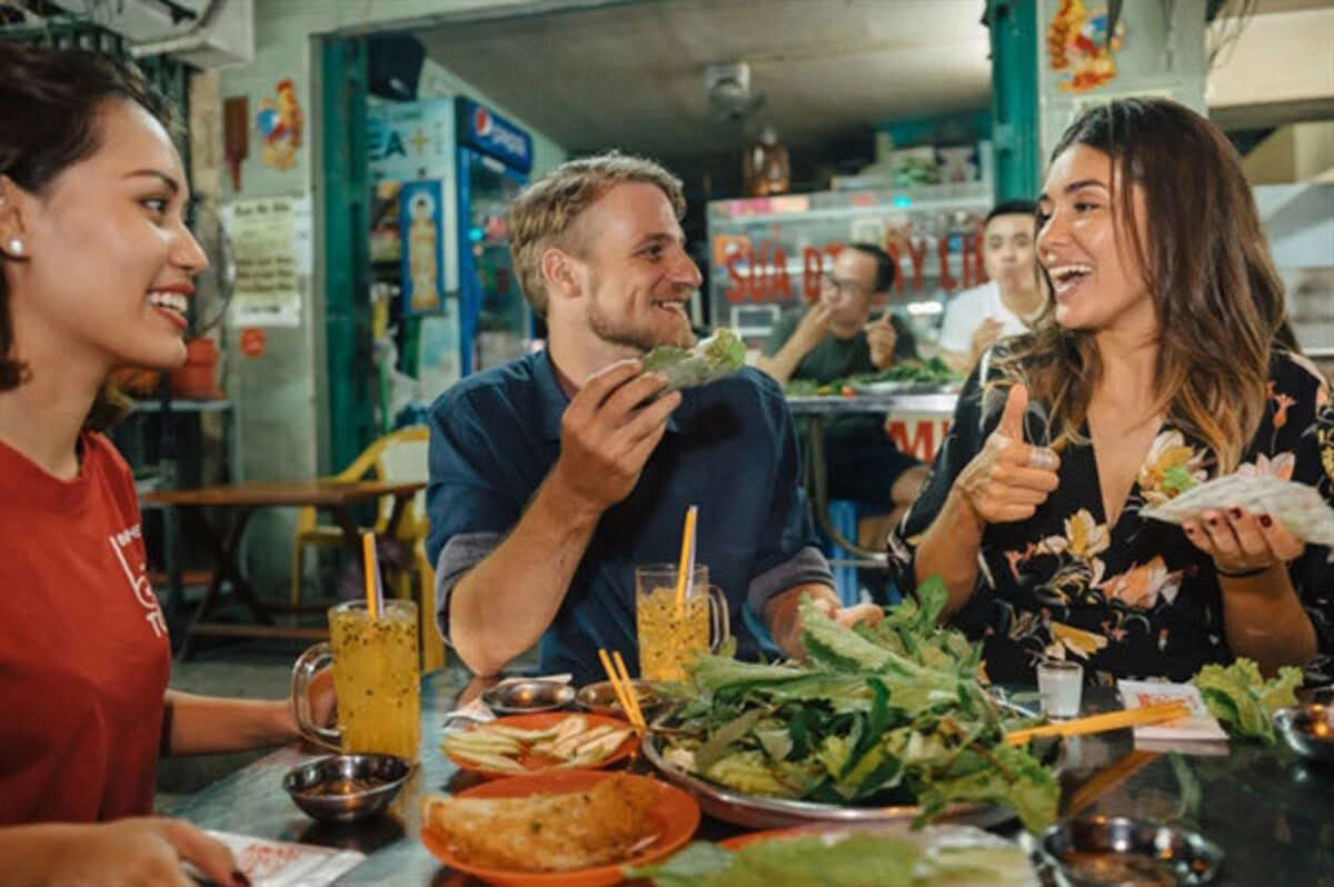 Travelers enjoying a plant-based meal at a local eatery