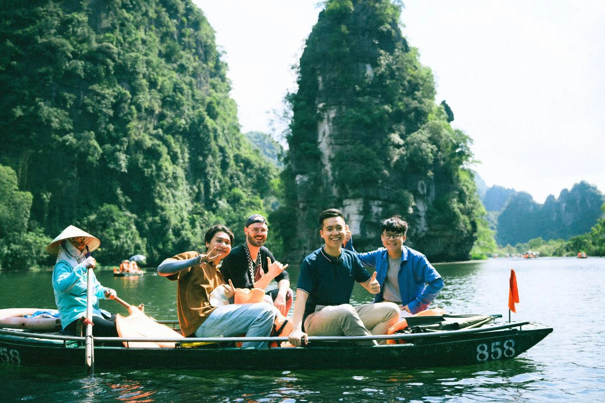 Tourists wearing comfortable clothes and sun hats on a boat