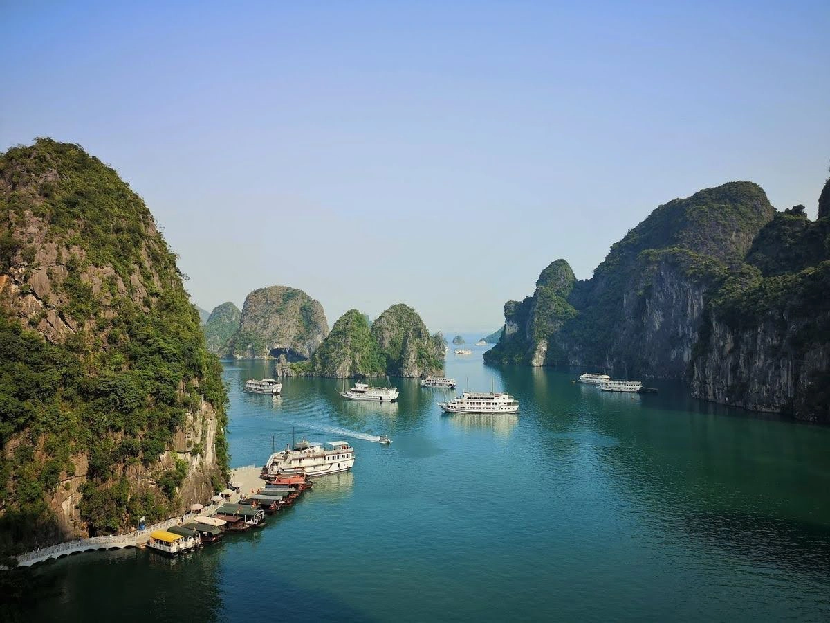 Cruise ships passing through a scenic limestone island channel