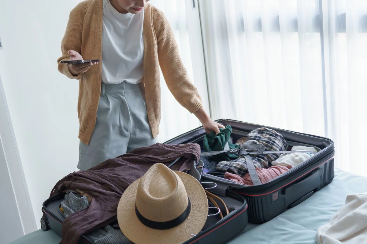 A traveler packing a light bag for an overnight trip