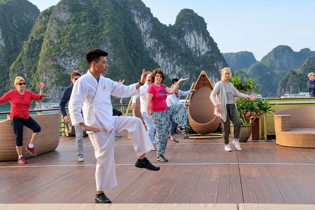Morning Tai Chi session surrounded by calm misty emerald waters